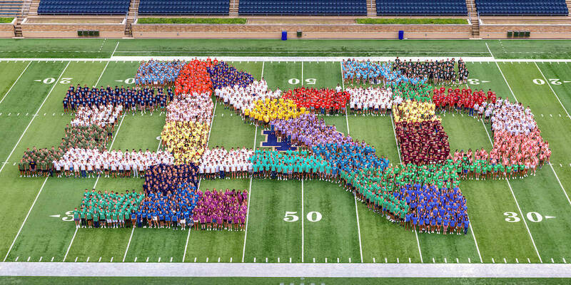 Class Of 2025 Group Photo - standing on the football field arranged into the shape of the interlocking ND